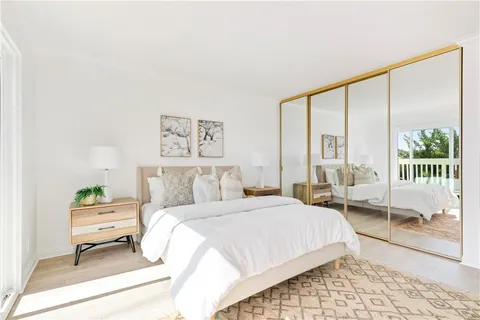 a bedroom with a bed and a large window