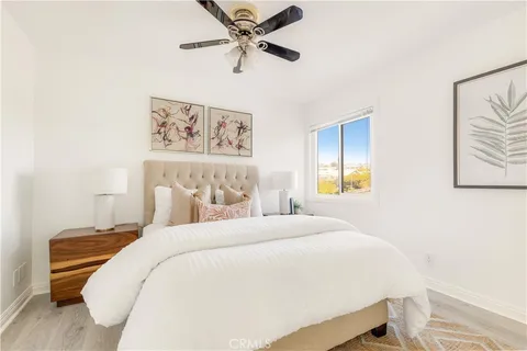 a bedroom with a bed and a painting on the wall