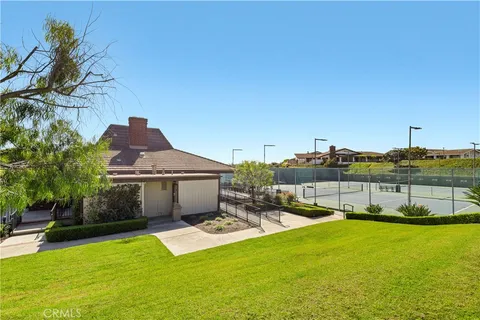 a view of a house with swimming pool and a yard