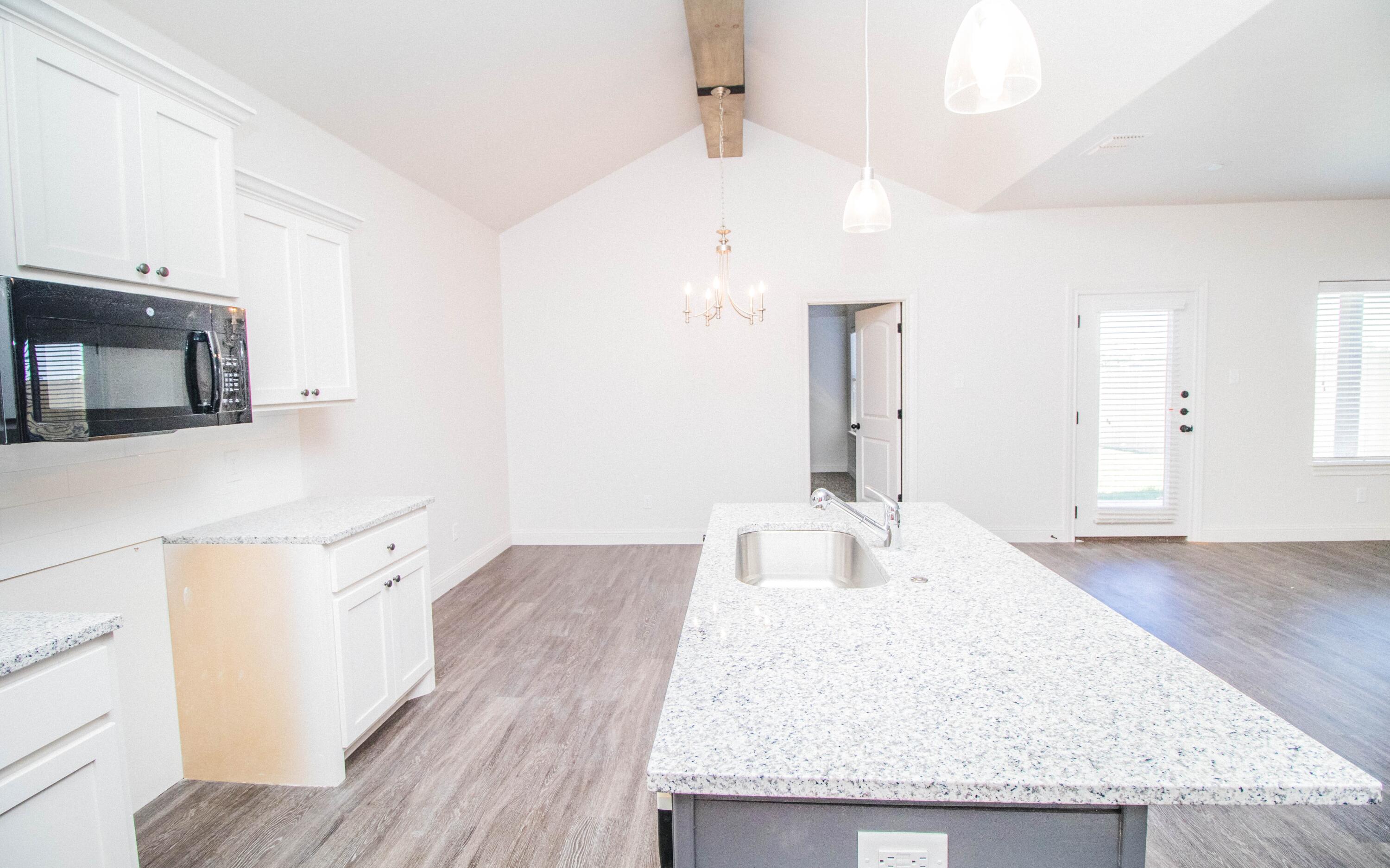 1613 102nd Street Lubbock, TX 79423 - Photo 6 of 18 a bathroom with a granite countertop double vanity sink and mirror