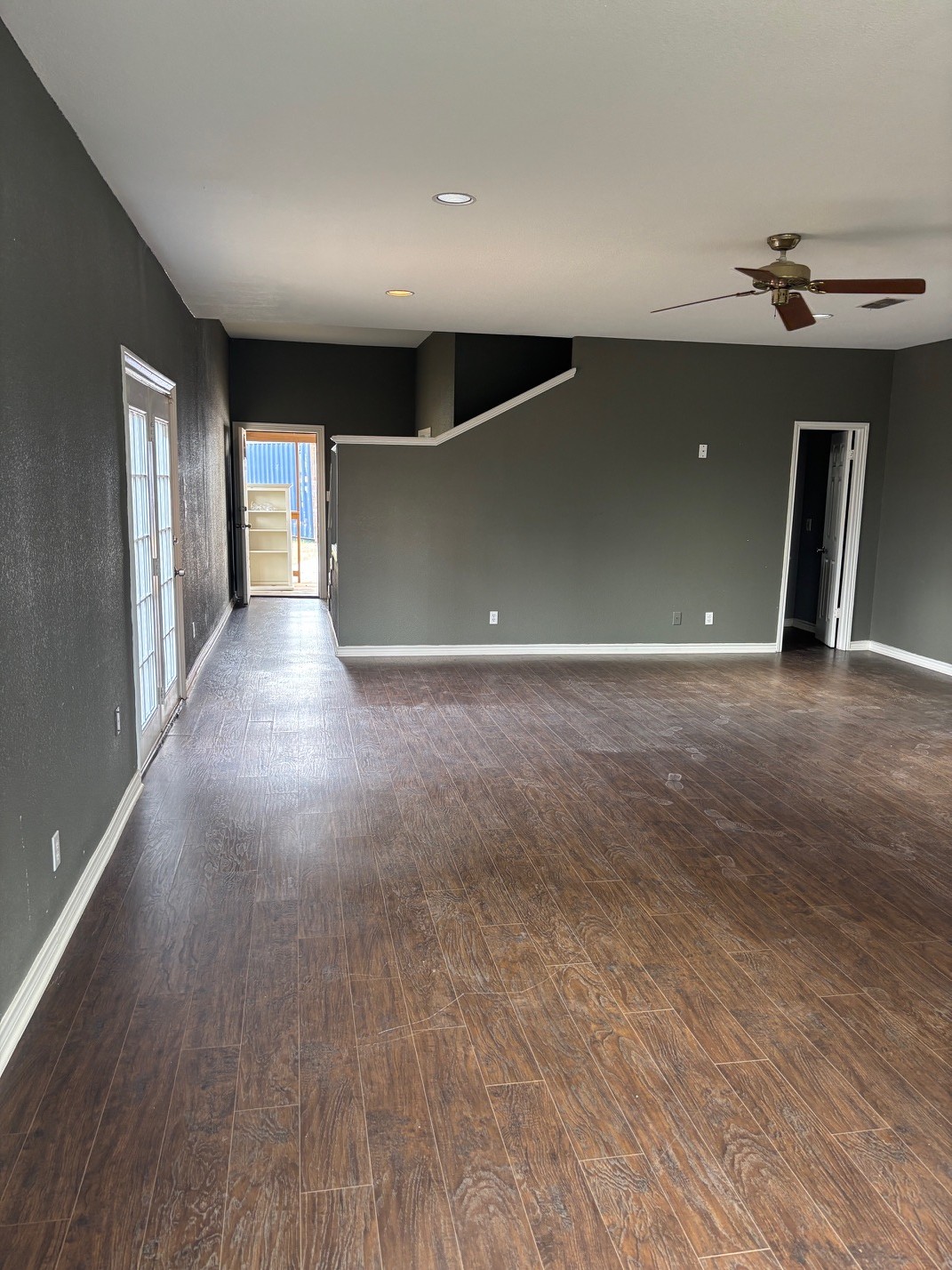 15401 Lariat Trail Austin, TX 78734 - Photo 8 of 23 Unfurnished room featuring dark wood-style floors, ceiling fan, and recessed lighting