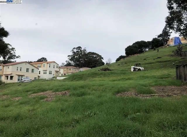 a view of a white house with a yard