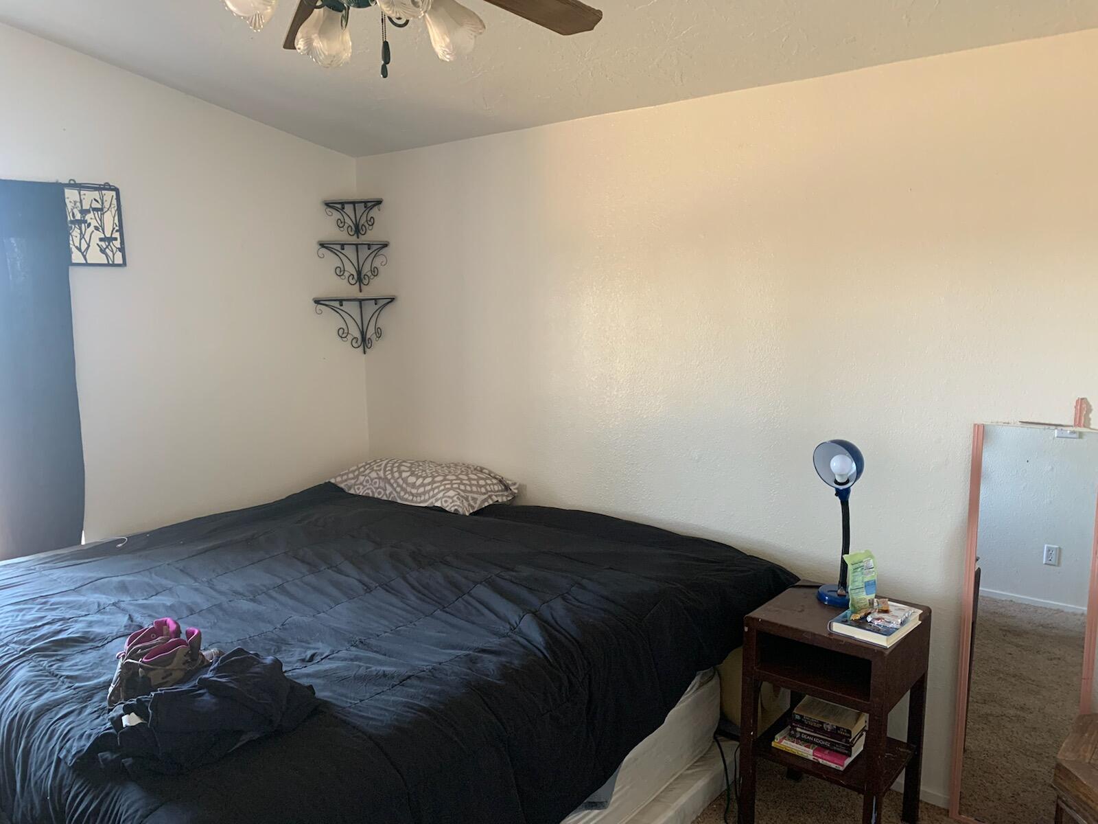 20567 Plymire Road Red Bluff, CA 96080 - Photo 13 of 20 a bedroom with a bed and a chandelier