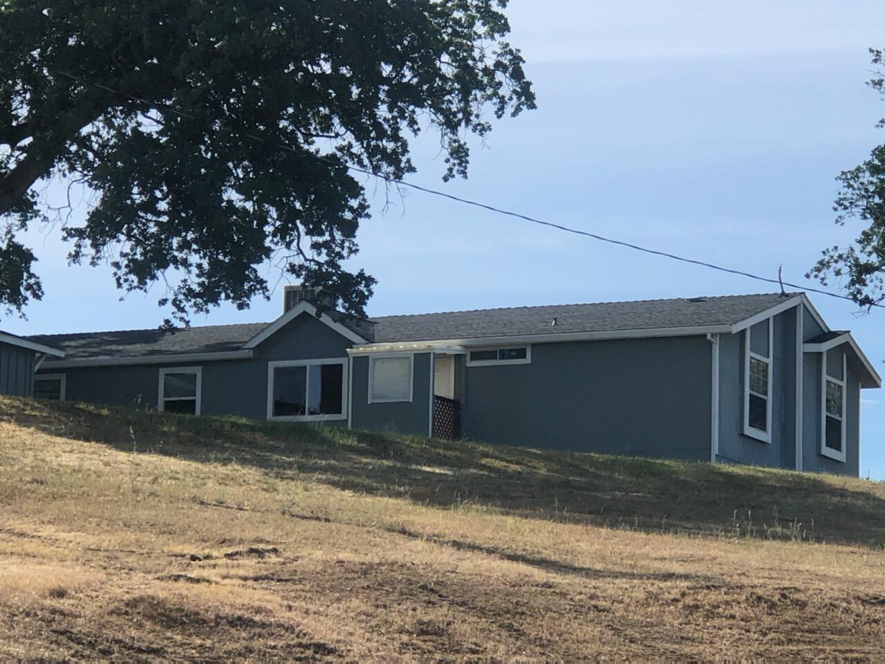 20567 Plymire Road Red Bluff, CA 96080 - Photo 3 of 20 a front view of a house with a yard and garage