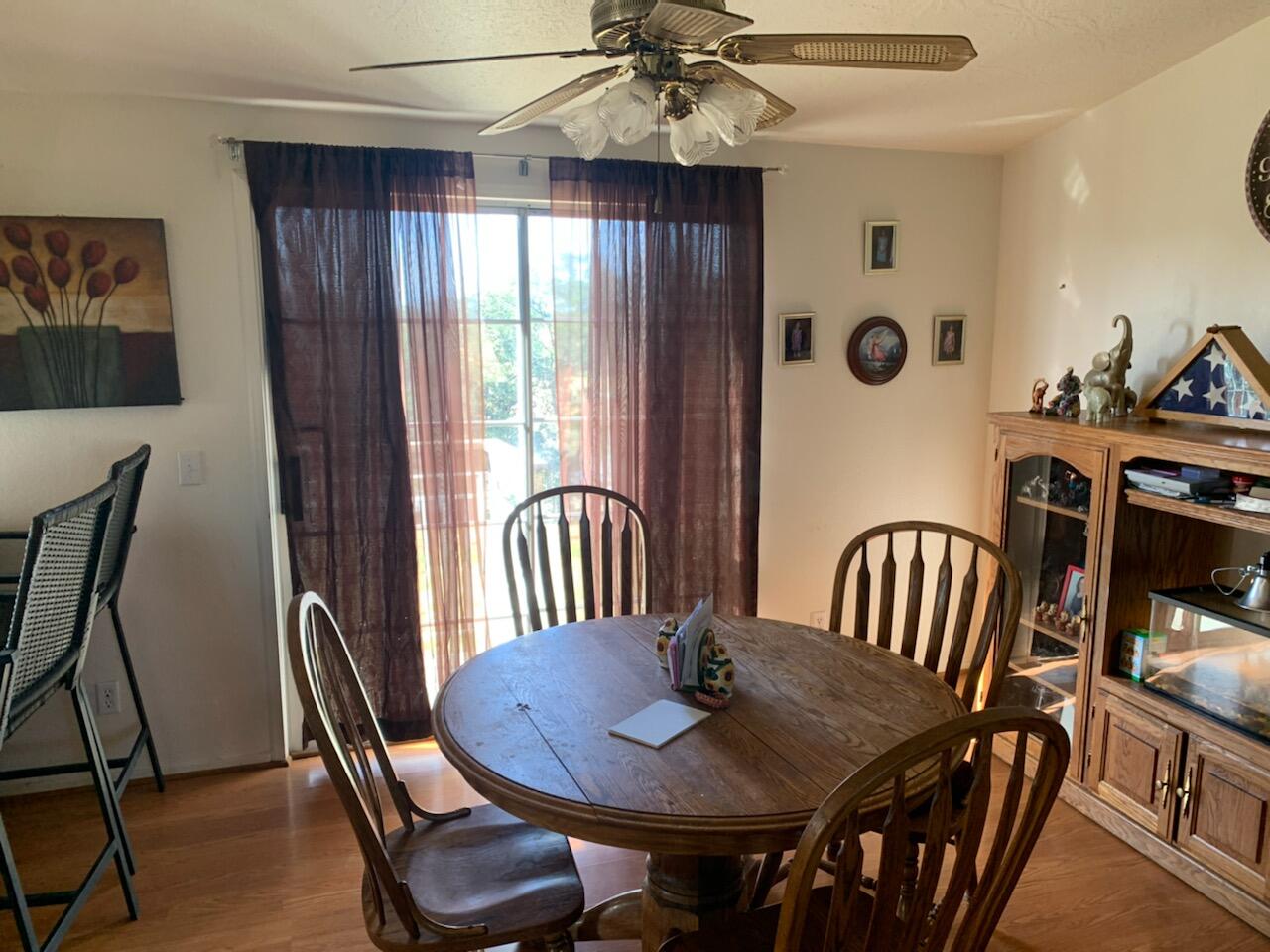 20567 Plymire Road Red Bluff, CA 96080 - Photo 5 of 20 a view of a dining room with furniture window and wooden floor