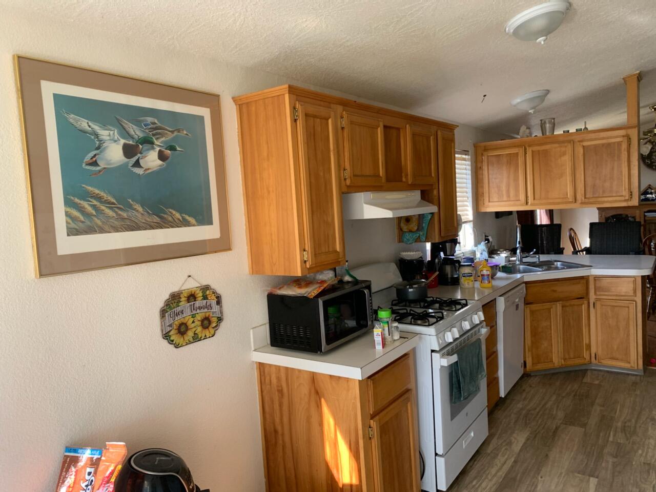 20567 Plymire Road Red Bluff, CA 96080 - Photo 6 of 20 a kitchen with a stove and a refrigerator