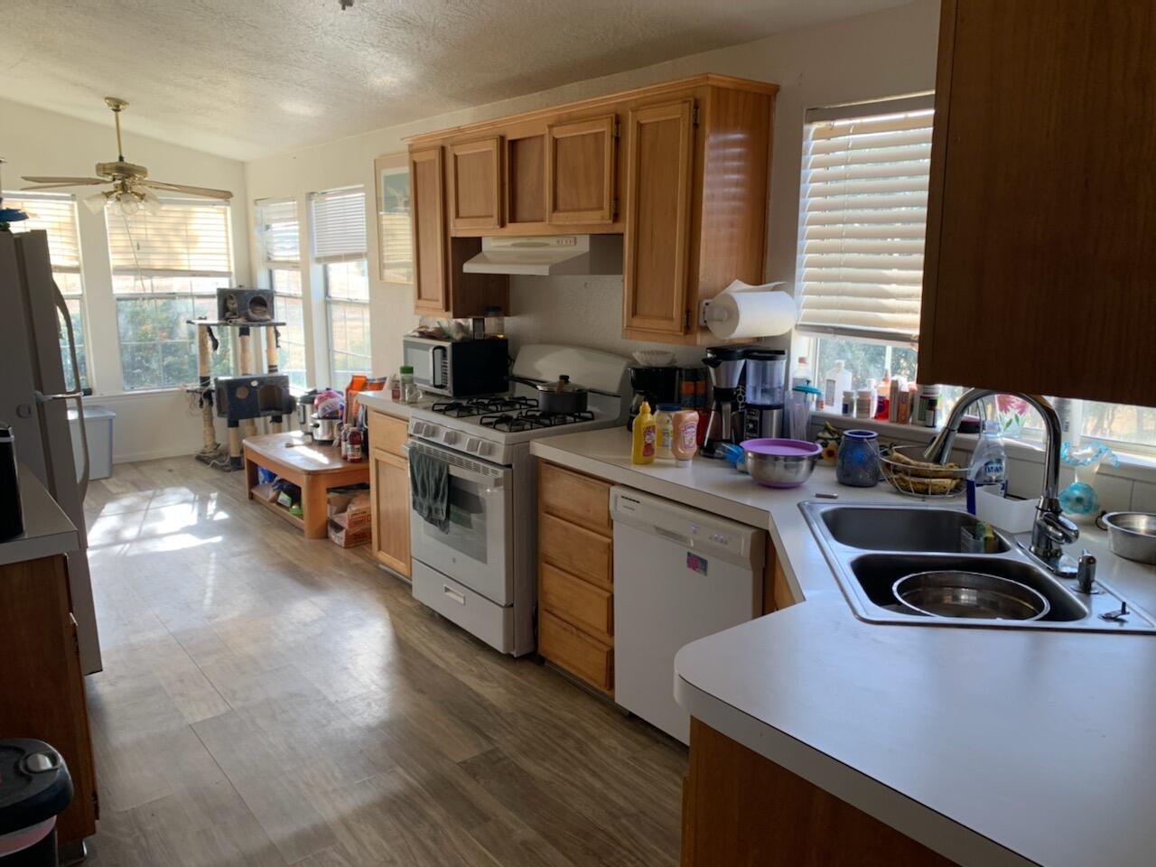 20567 Plymire Road Red Bluff, CA 96080 - Photo 7 of 20 a kitchen with a sink a stove and cabinets