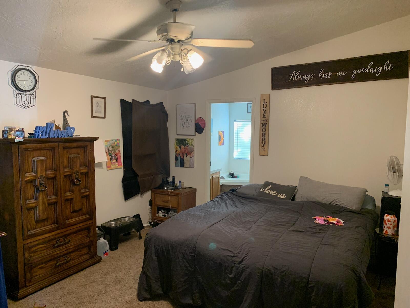 20567 Plymire Road Red Bluff, CA 96080 - Photo 10 of 20 a bedroom with a bed and a chandelier