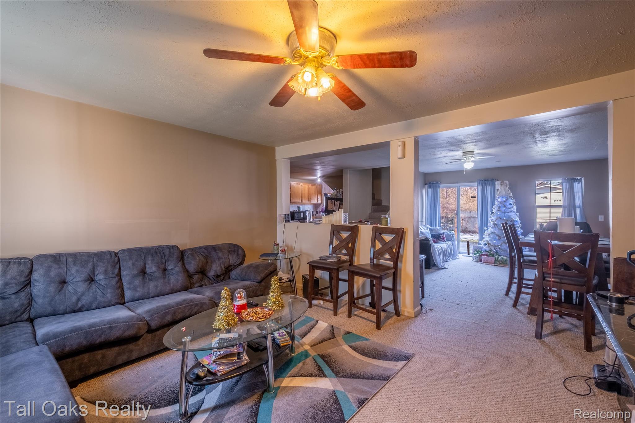 6054 East Pierson Road Flint, MI 48506 - Photo 25 of 38 Living room with light colored carpet, a textured ceiling, and a ceiling fan