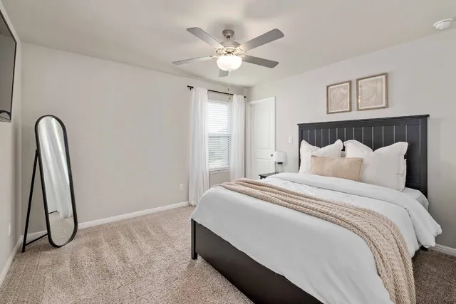 a bedroom with furniture and a window