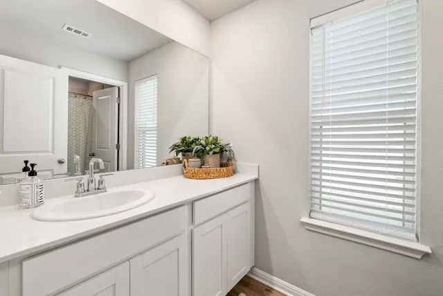 a bathroom with a shower and a sink