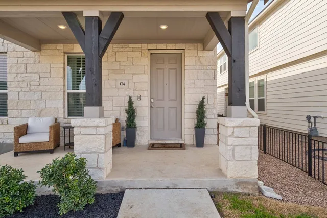 a view of a patio with couches chairs and wooden floor