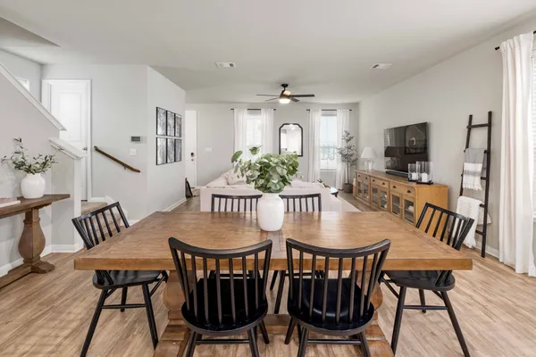 a view of a a dining room with furniture window and wooden floor