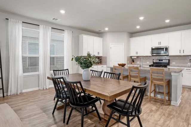 a view of a dining room with furniture and wooden floor