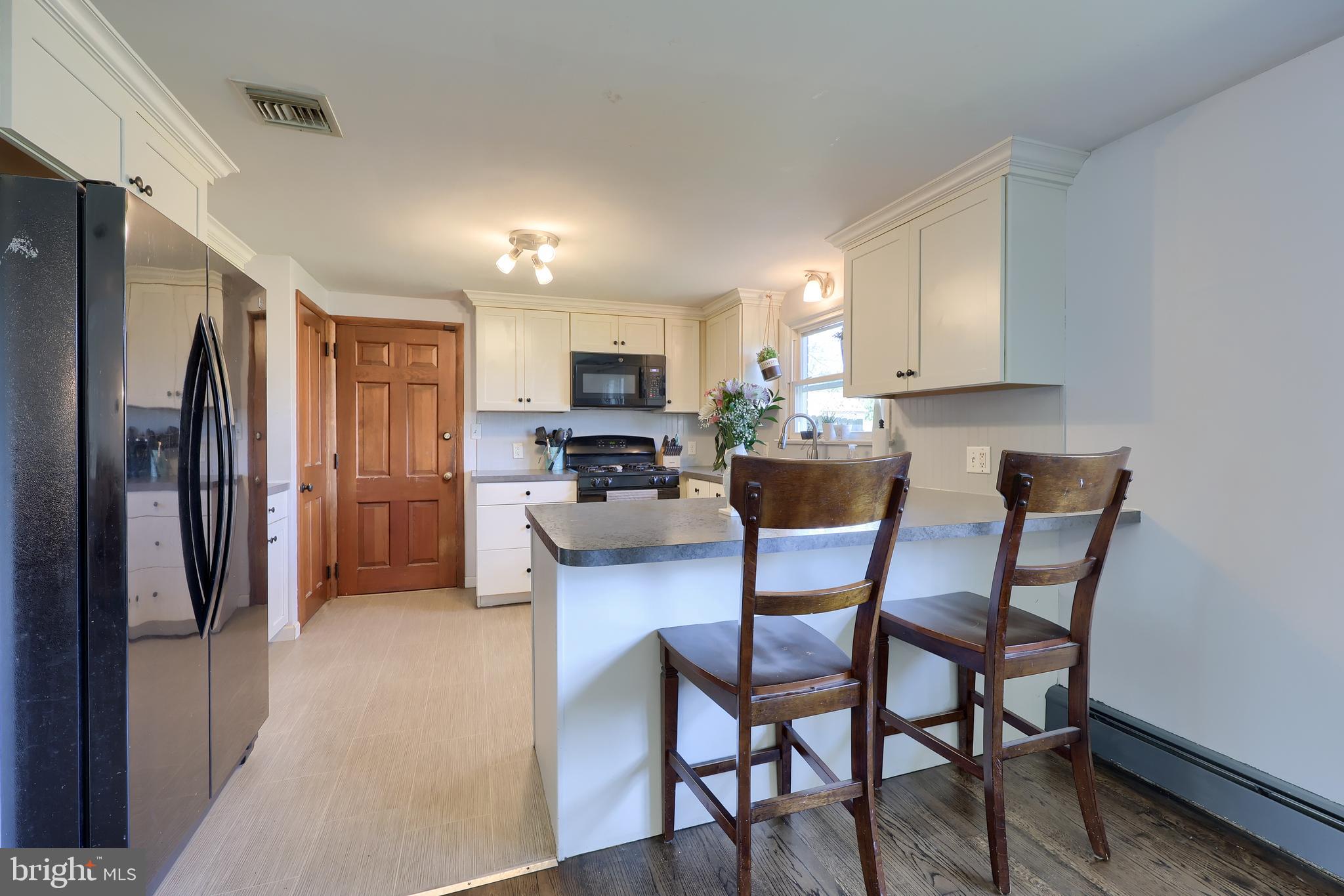 2033 Robindale Avenue Lancaster, PA 17601 - Photo 17 of 47 a kitchen view with a dining table chairs refrigerator and cabinets