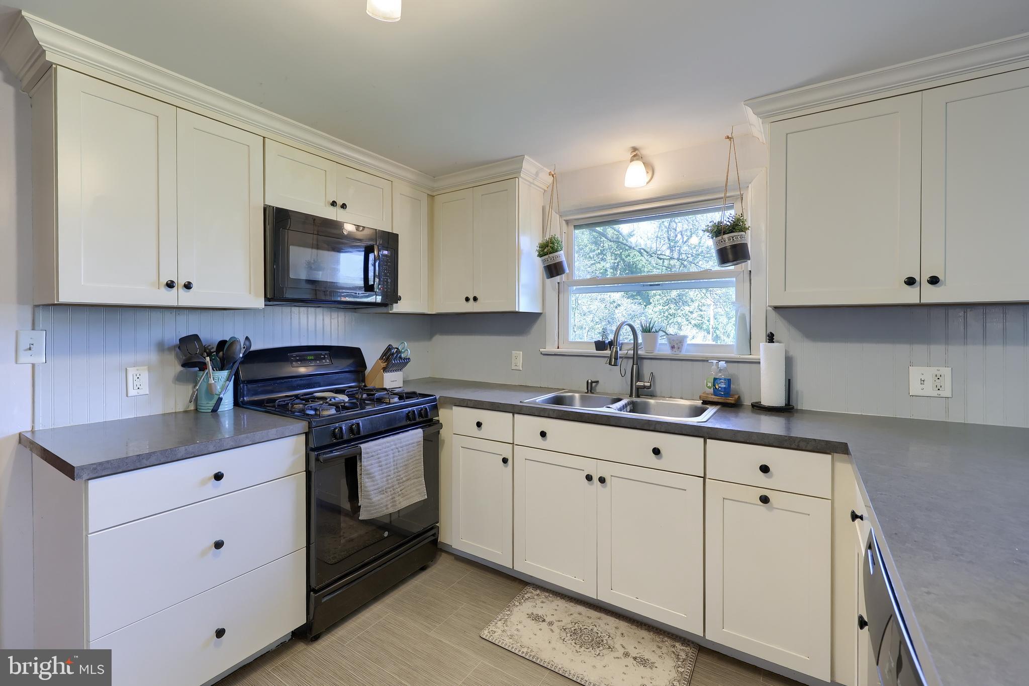 2033 Robindale Avenue Lancaster, PA 17601 - Photo 18 of 47 a kitchen with stainless steel appliances granite countertop white cabinets a sink and a stove