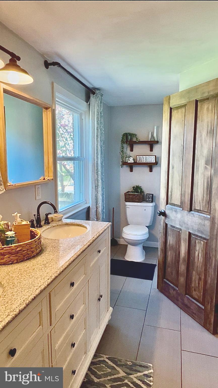 2033 Robindale Avenue Lancaster, PA 17601 - Photo 26 of 47 a en suite bathroom with a granite countertop sink and a mirror
