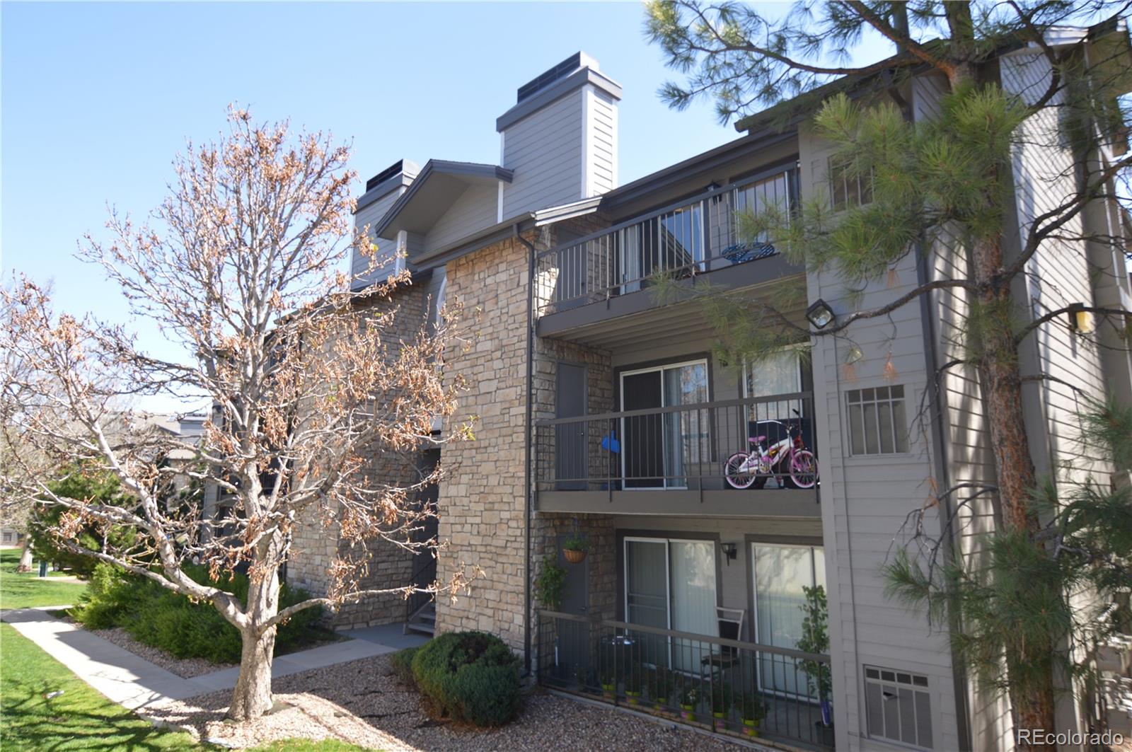 2575 South Syracuse Way, Unit J308 Denver, CO 80231 - Photo 1 of 14 a front view of a house with plants