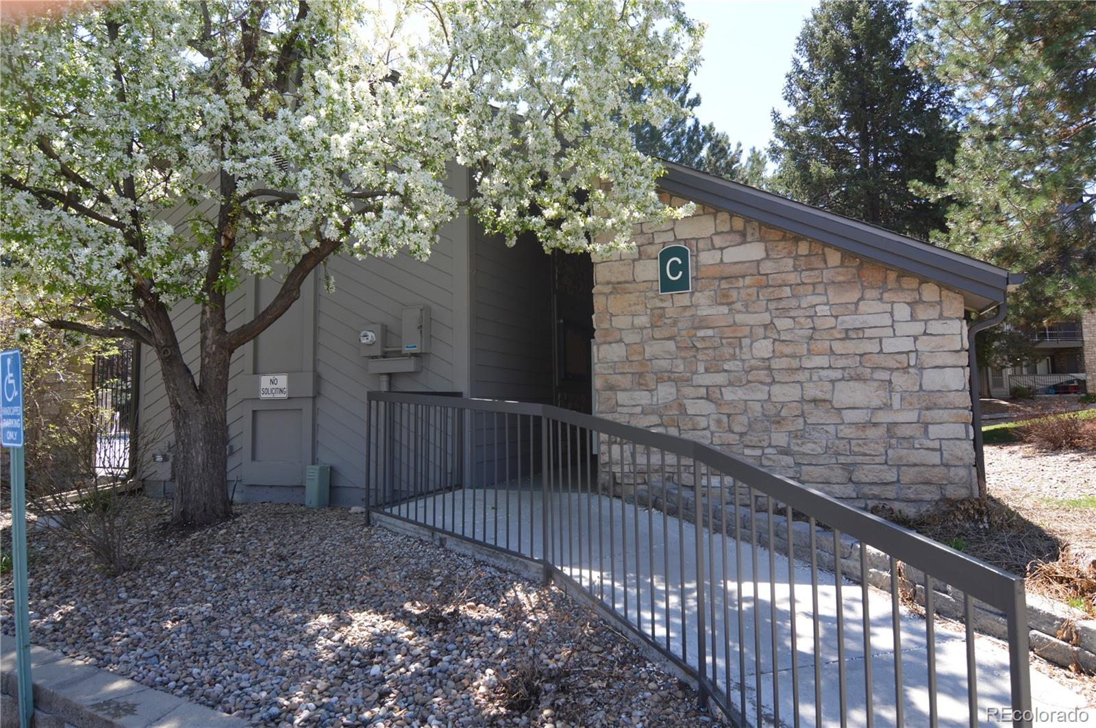 2575 South Syracuse Way, Unit J308 Denver, CO 80231 - Photo 13 of 14 a view of a house with a tree in the background