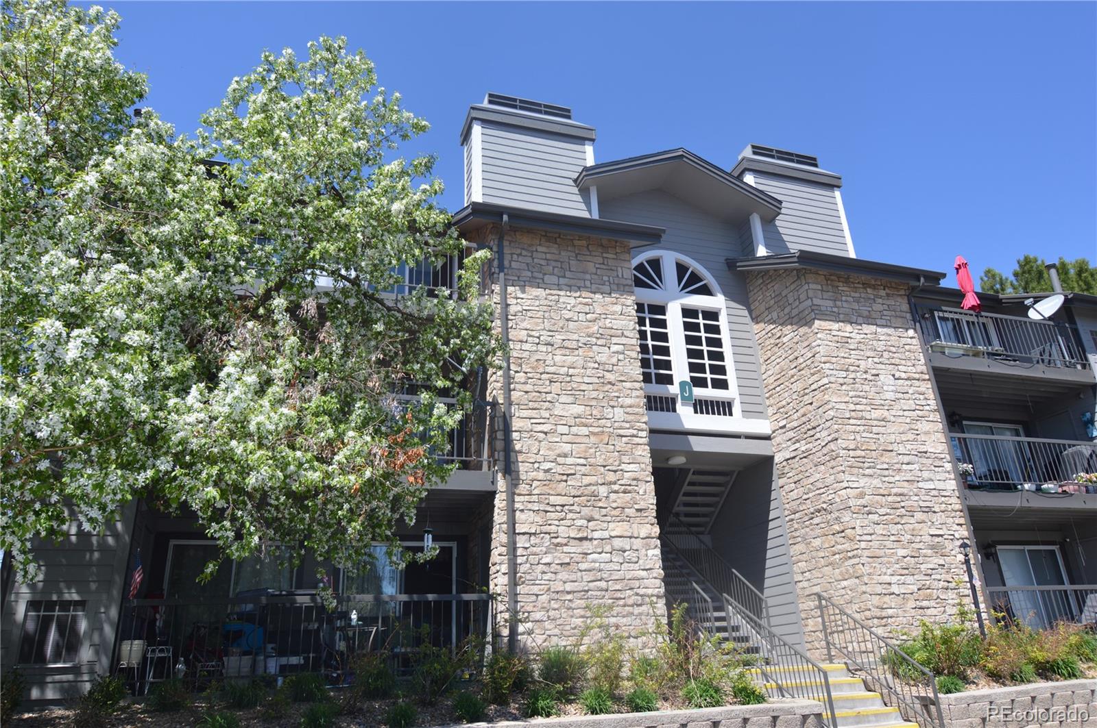 2575 South Syracuse Way, Unit J308 Denver, CO 80231 - Photo 2 of 14 a front view of a house with plants