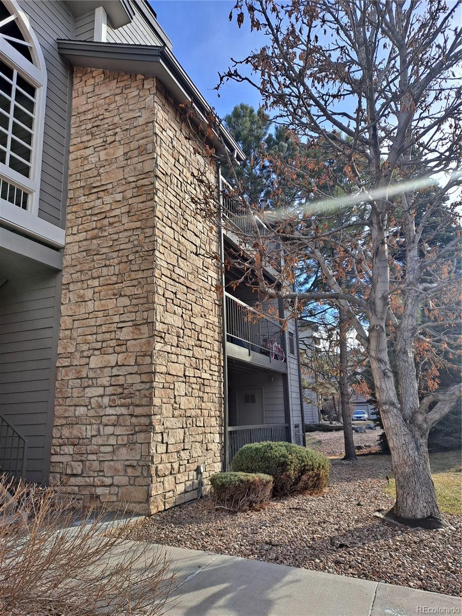 2575 South Syracuse Way, Unit J308 Denver, CO 80231 - Photo 3 of 14 a brick building with a tree in front of it