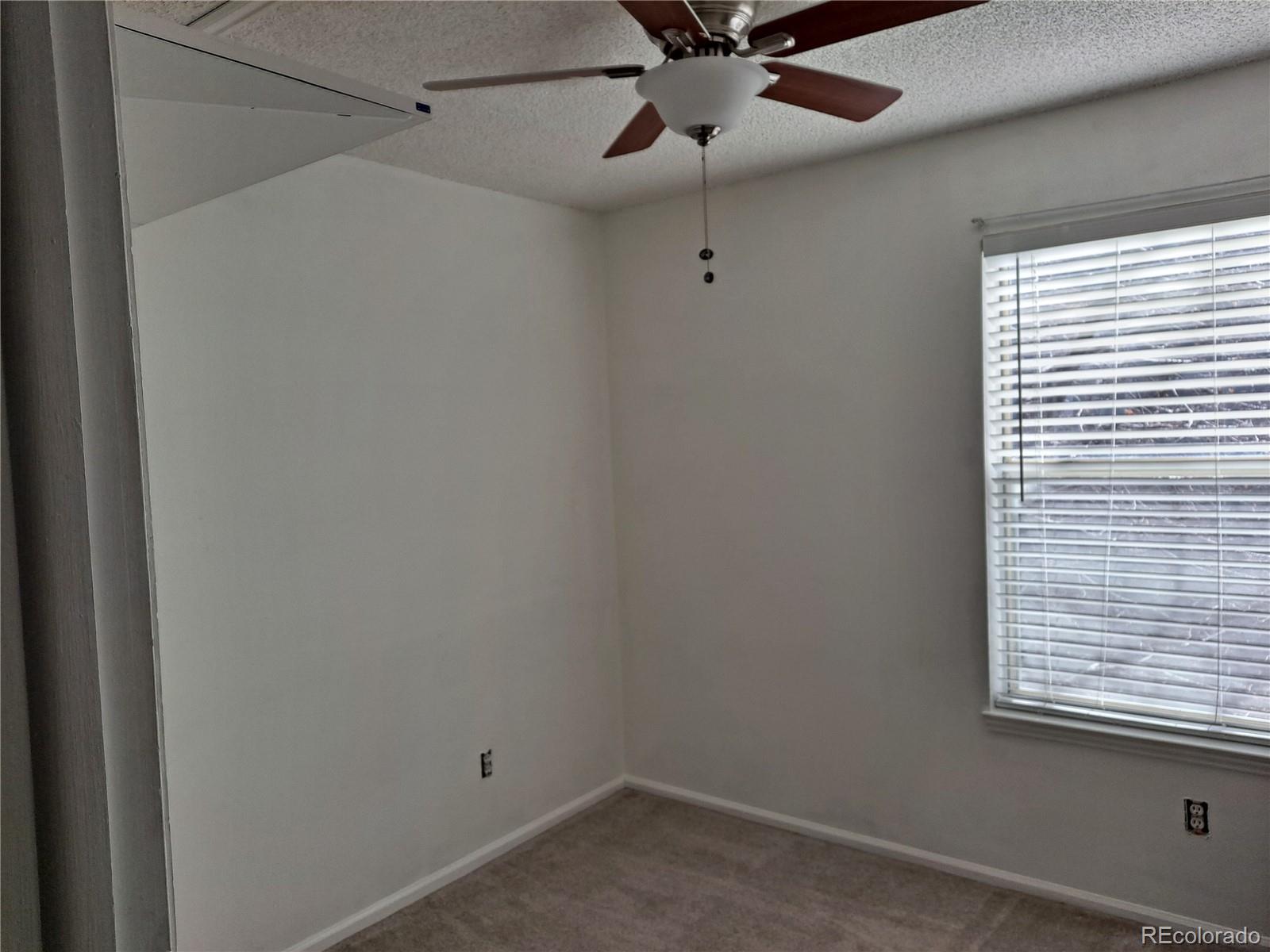 2575 South Syracuse Way, Unit J308 Denver, CO 80231 - Photo 10 of 14 a view of a room with a window and a fan