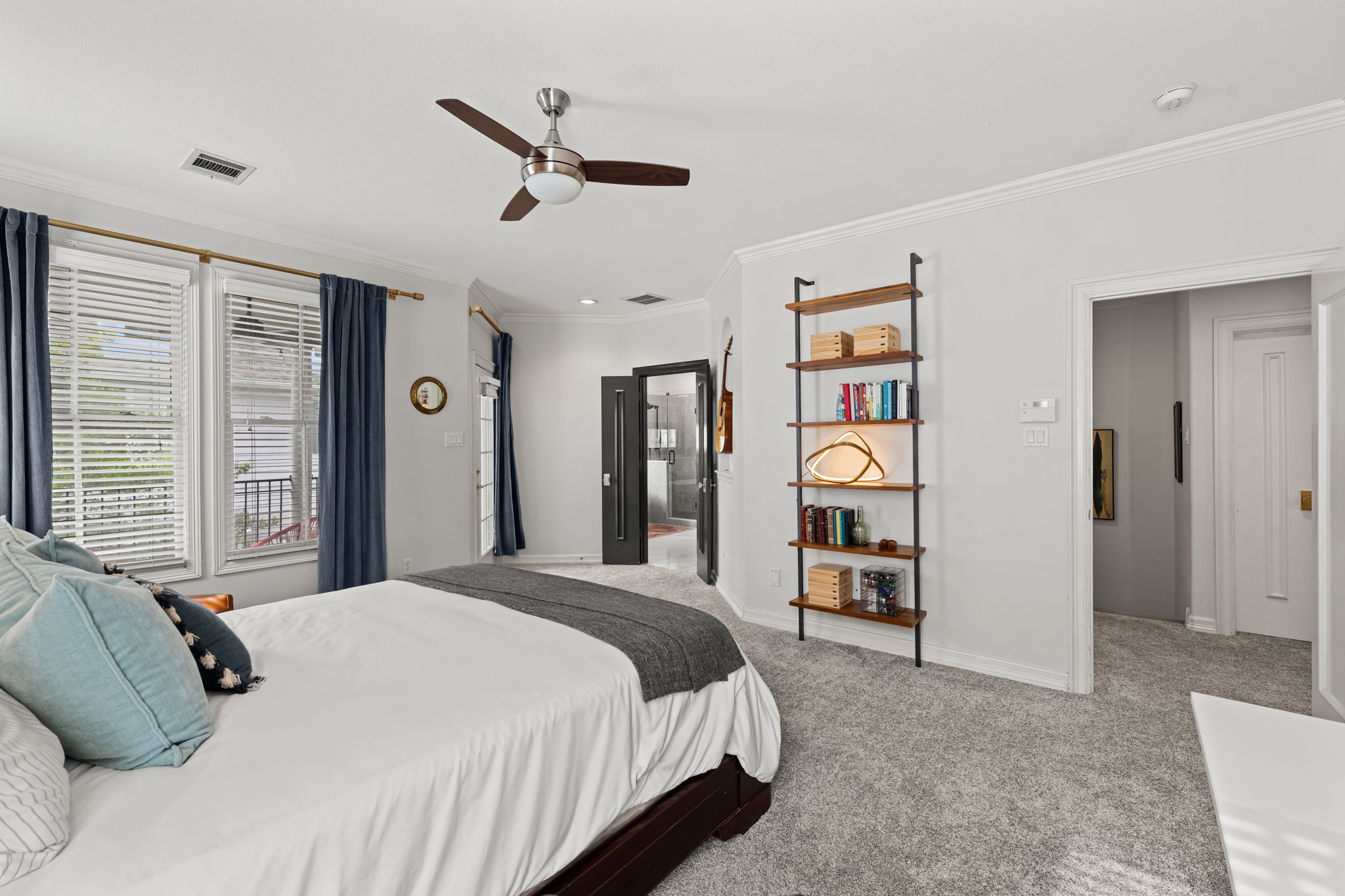520 Oxford Street, Unit F Houston, TX 77007 - Photo 26 of 38 This angle of the primary bedroom reveals the direct connection to the fully renovated en-suite bath and the custom walk-in closet with lighting beyond.