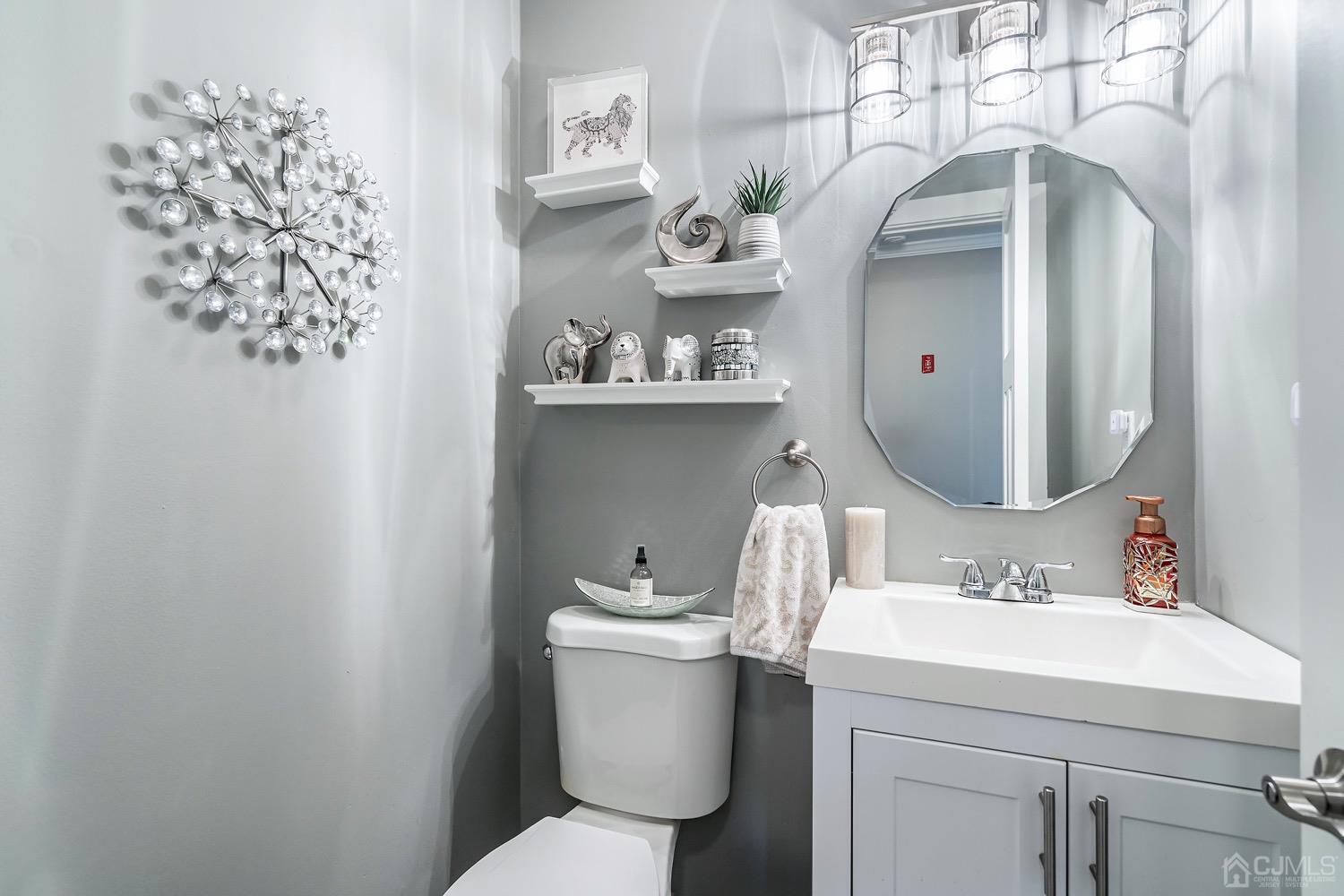 18 4th Street Barnegat, NJ 08005 - Photo 11 of 27 a bathroom with a toilet sink and mirror