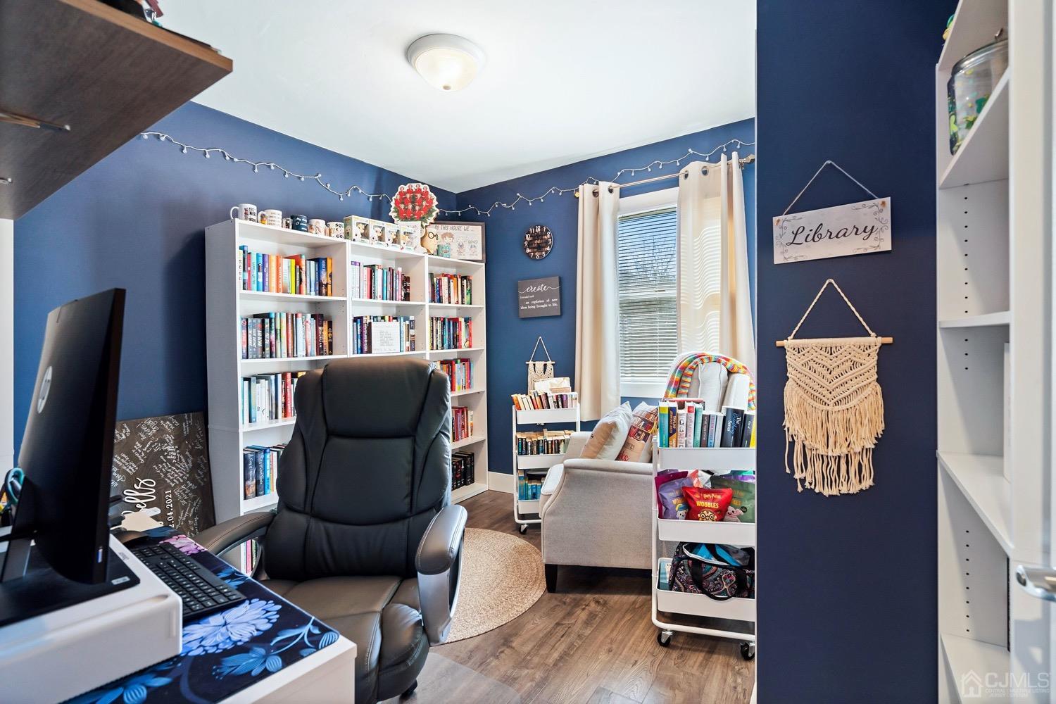 18 4th Street Barnegat, NJ 08005 - Photo 14 of 27 a living room with furniture and a bookshelf