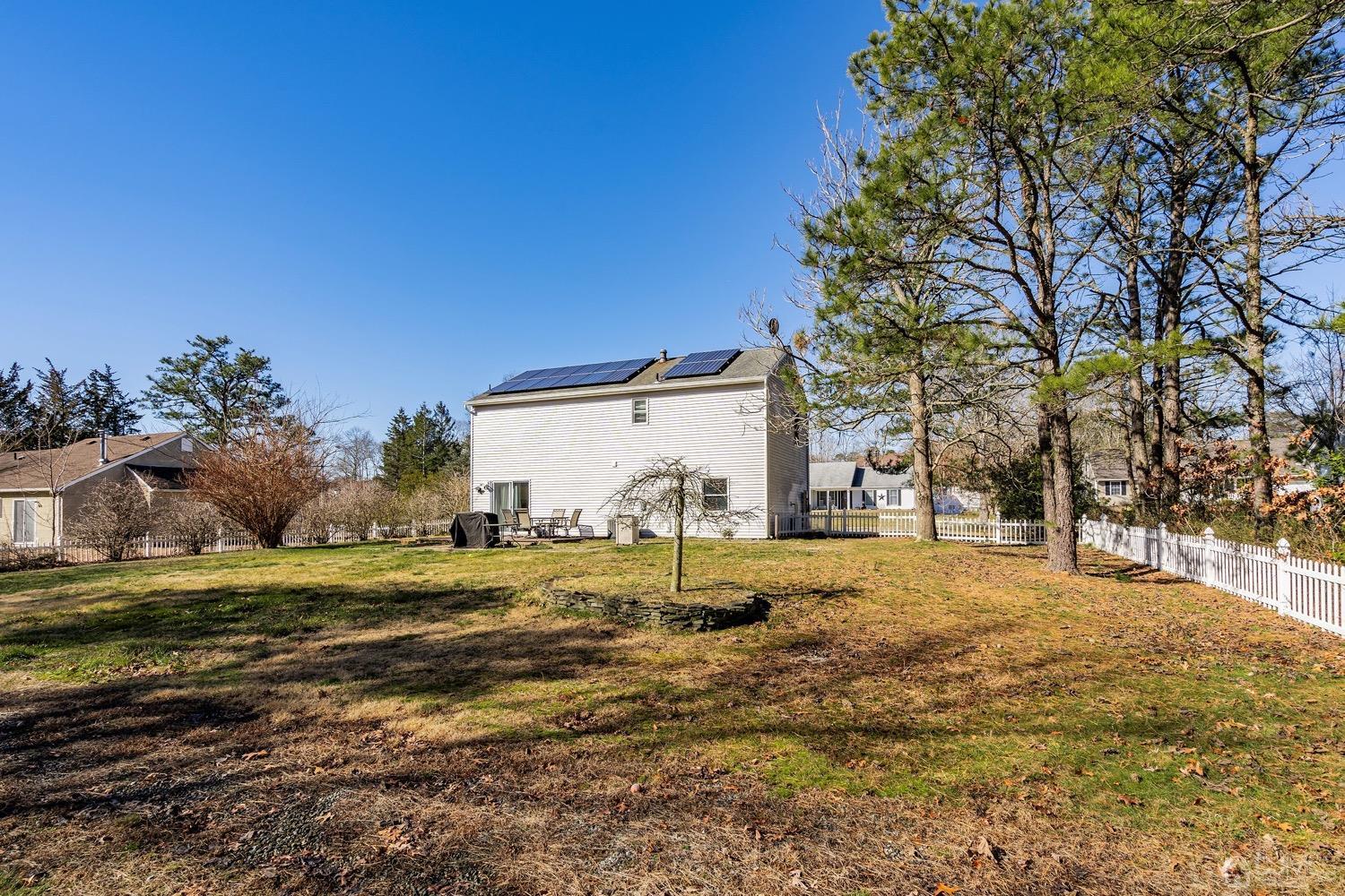 18 4th Street Barnegat, NJ 08005 - Photo 23 of 27 a view of a yard with a house and large trees