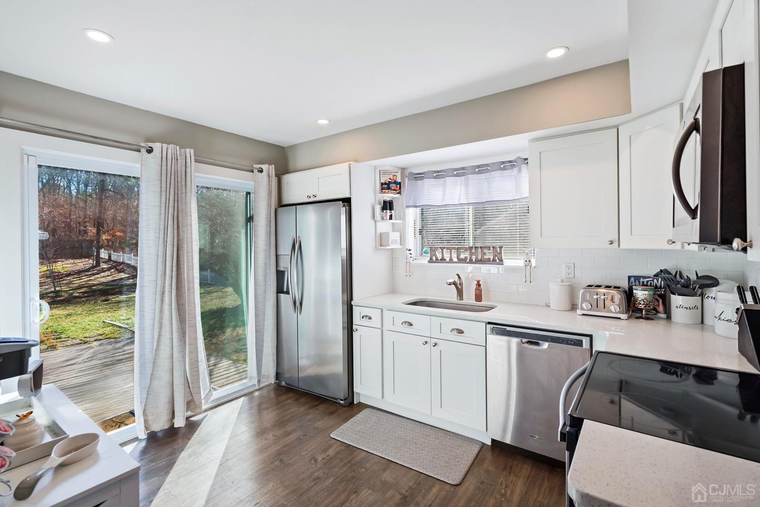 18 4th Street Barnegat, NJ 08005 - Photo 8 of 27 a kitchen with a sink stainless steel appliances and cabinets
