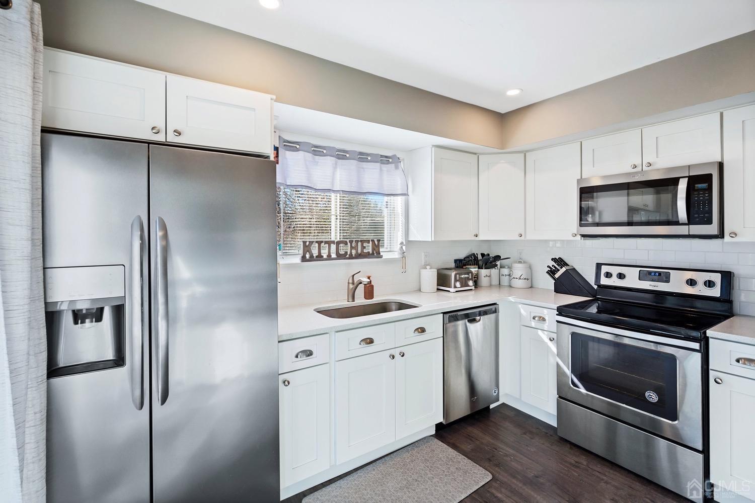 18 4th Street Barnegat, NJ 08005 - Photo 9 of 27 a kitchen with a refrigerator stove and microwave