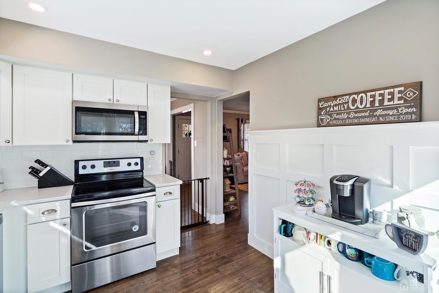 18 4th Street Barnegat, NJ 08005 - Photo 10 of 27 a kitchen with granite countertop a stove and a microwave