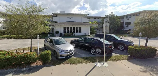 a front view of a house with garden and patio