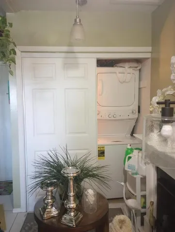 a vase of flowers sitting on a table with wooden floor