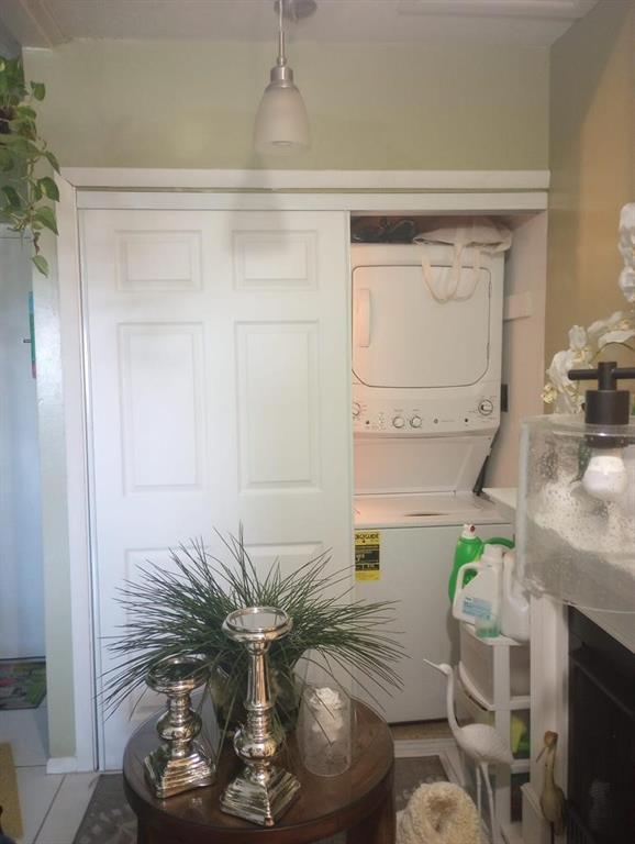 1250 East Sample Road, Unit 307 Pompano Beach, FL 33064 - Photo 5 of 11 a vase of flowers sitting on a table with wooden floor