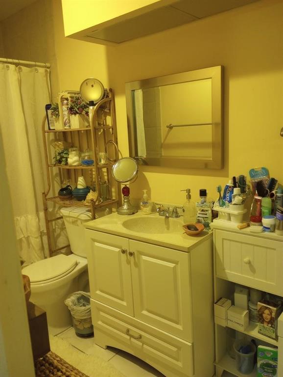 1250 East Sample Road, Unit 307 Pompano Beach, FL 33064 - Photo 7 of 11 a bathroom with a sink and mirror with toilet