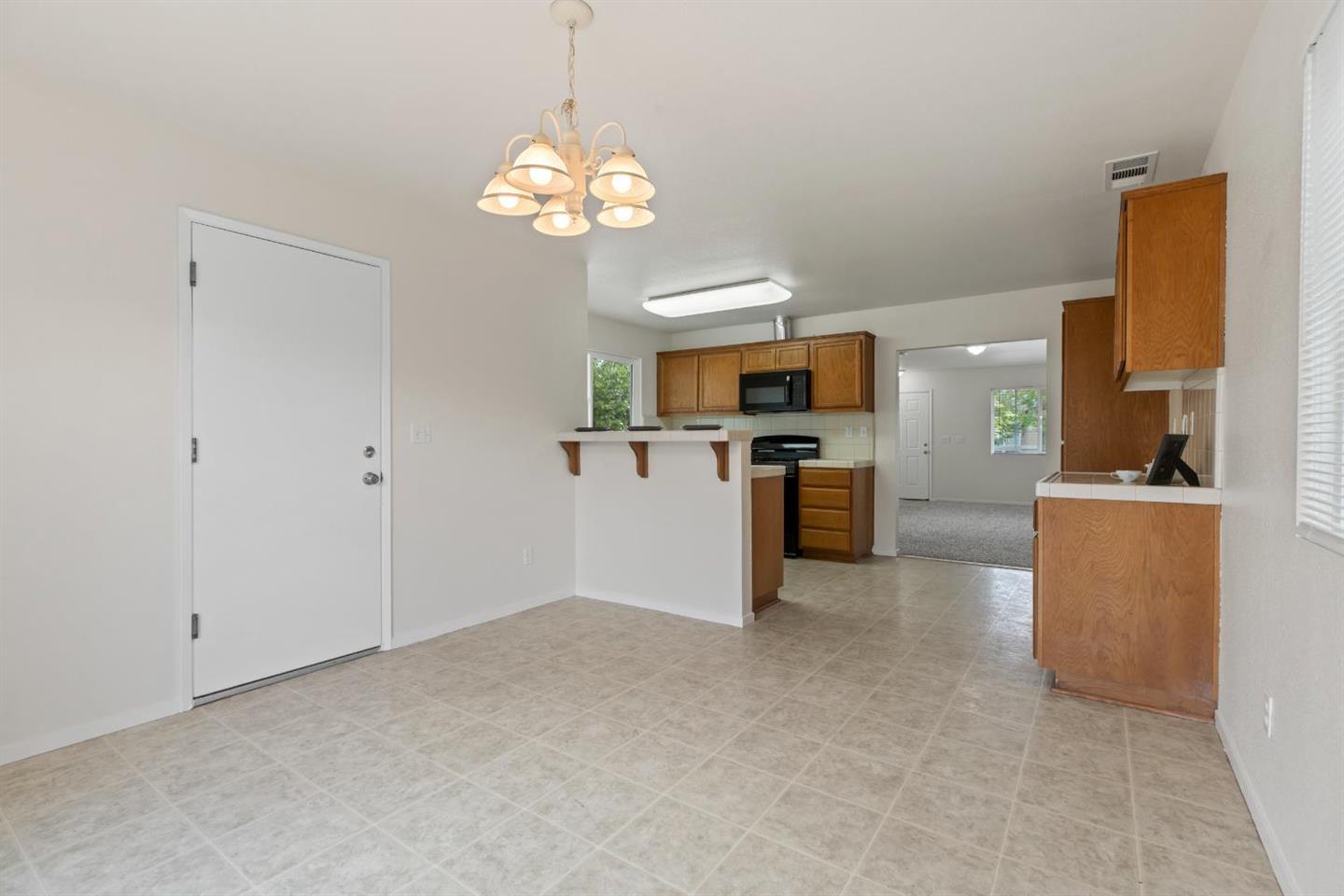 4347 Mathias Way Merced, CA 95348 - Photo 7 of 20 a view of a kitchen with a sink and dishwasher a refrigerator with white cabinets
