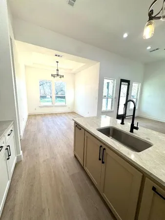a view of a kitchen with a sink and wooden floor