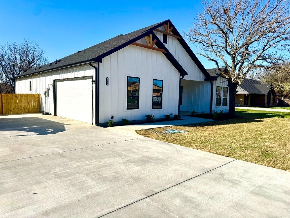 1106 East Sixth Street Springtown, TX 76082 - Photo 2 of 25 a front view of a house with a yard