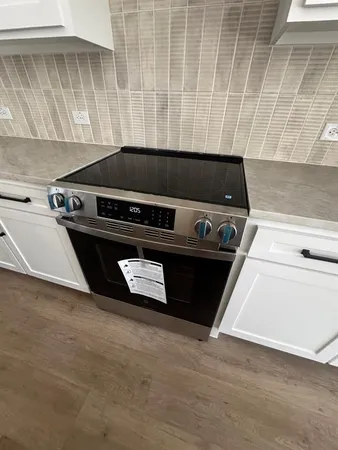 a close up of a stove and a microwave oven