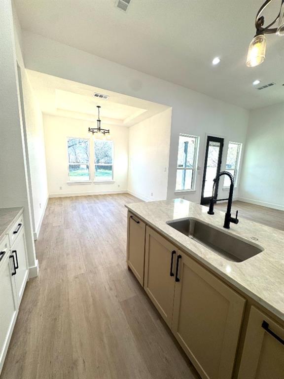 1106 East Sixth Street Springtown, TX 76082 - Photo 10 of 25 a view of a kitchen with a sink and wooden floor