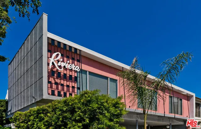 a front view of a house with plants