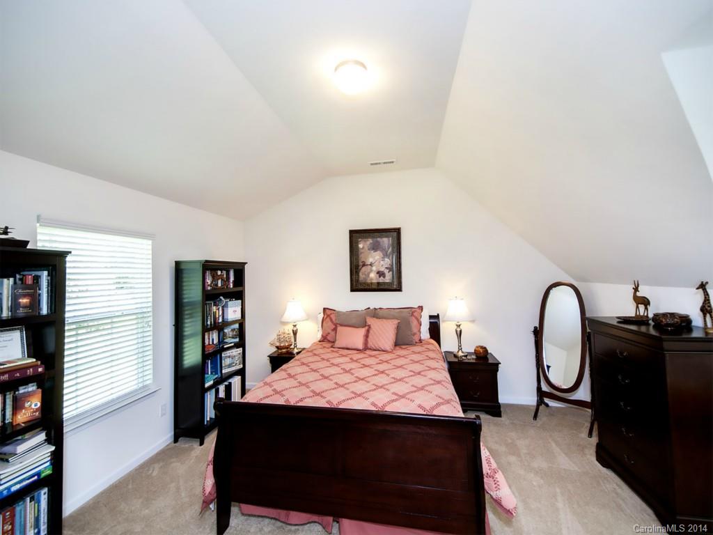392 Wellridge Drive Fort Mill, SC 29708 - Photo 16 of 21 a bedroom with a bed a table and bookshelf