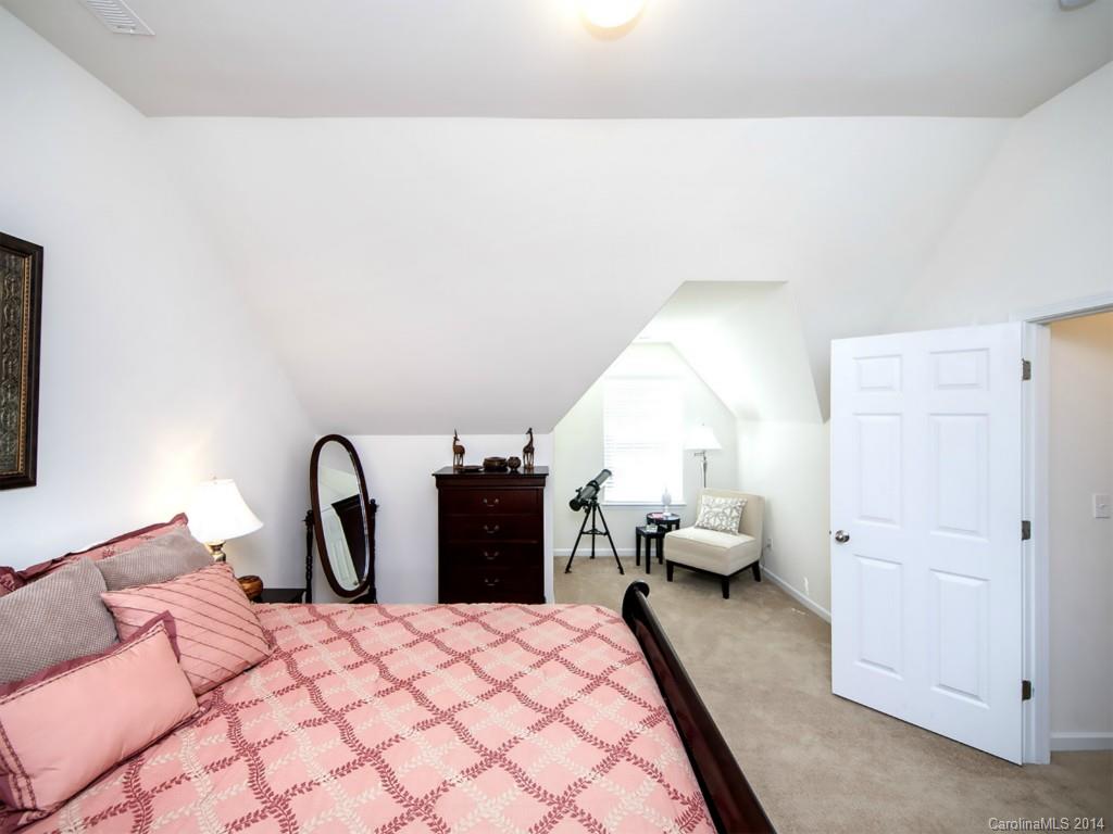 392 Wellridge Drive Fort Mill, SC 29708 - Photo 17 of 21 a bedroom with a bed and a potted plant