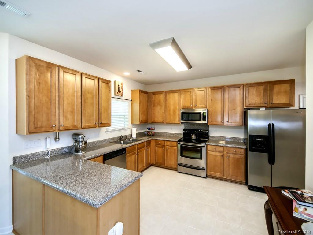 392 Wellridge Drive Fort Mill, SC 29708 - Photo 8 of 21 a kitchen with stainless steel appliances granite countertop a sink stove and refrigerator