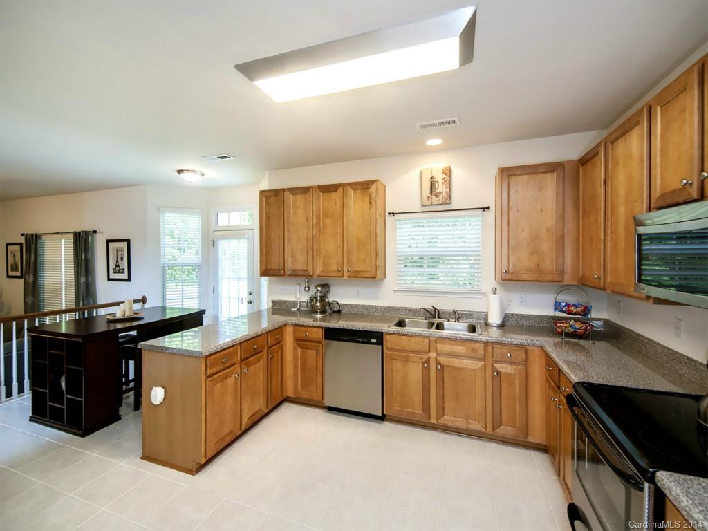 392 Wellridge Drive Fort Mill, SC 29708 - Photo 9 of 21 a kitchen with a sink a stove and cabinets