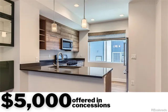 a kitchen with stainless steel appliances granite countertop a sink and a stove
