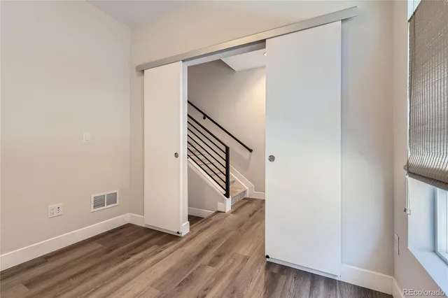 a view of an entryway with wooden floor