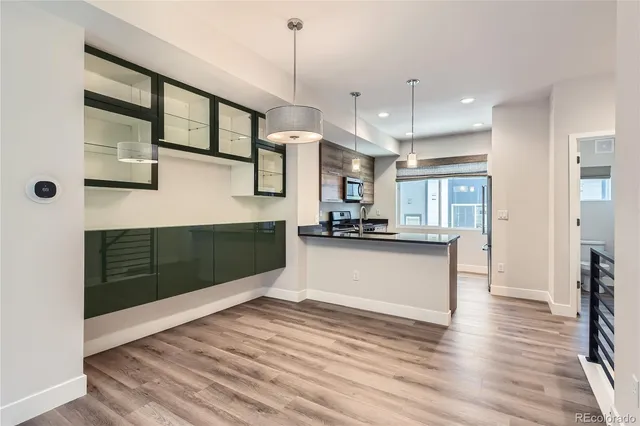 a kitchen with stainless steel appliances kitchen island granite countertop a stove a sink and a refrigerator